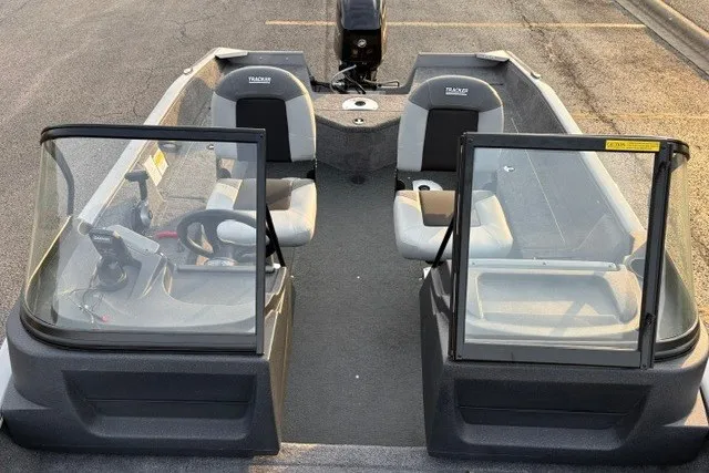 Slide: The Image of 2027 Tracker Pro Guide V-16 WT boat interior with dual seats and windshield. - 16
