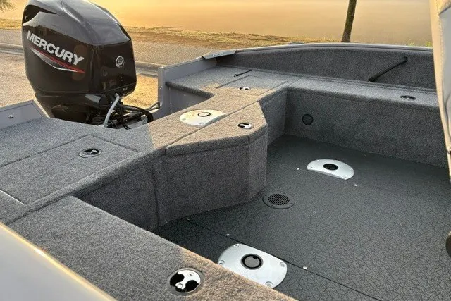 Slide: The Image of 2027 Tracker Pro Guide V-16 WT boat interior with Mercury engine at sunrise. - 26
