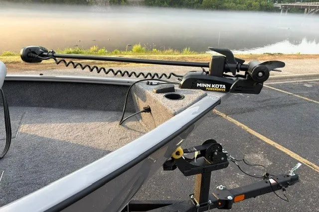 Slide: The Image of 2027 Tracker Pro Guide V-16 WT boat with Minn Kota trolling motor by a misty lake. - 23