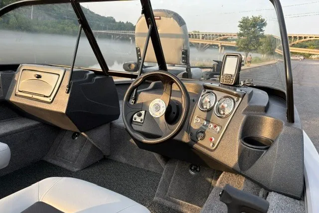 Slide: The Image of Interior of 2027 Tracker Pro Guide V-16 WT boat with steering wheel and dashboard. - 14