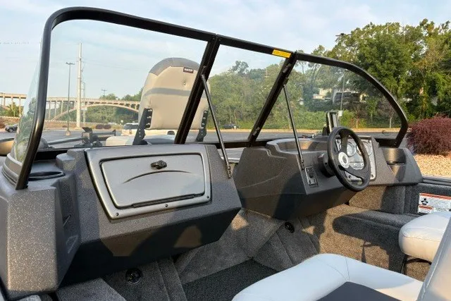 Slide: The Image of 2027 Tracker Pro Guide V-16 WT boat interior with steering wheel and dashboard. - 18