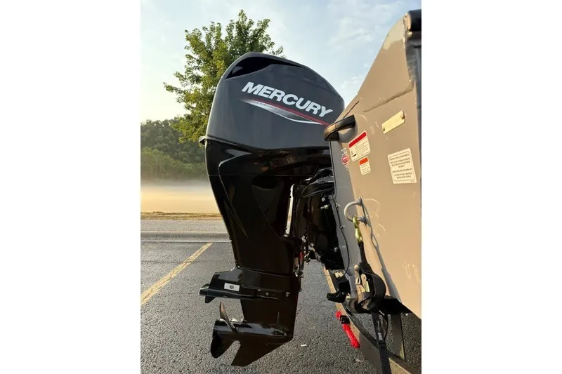 Slide: The Image of 2027 Tracker Pro Guide V-16 WT with Mercury outboard motor in a scenic setting. - 27