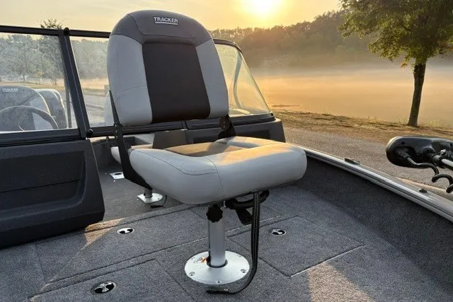Slide: The Image of 2027 Tracker Pro Guide V-16 WT boat seat at sunrise on a calm lake. - 24