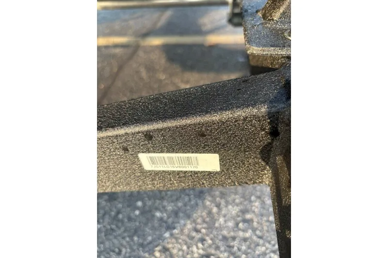 Slide: The Image of Close-up of a 2027 Tracker Pro Guide V-16 WT boat trailer with a visible barcode. - 59