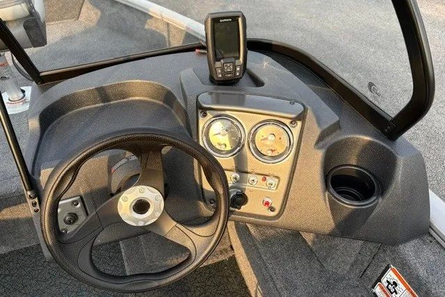 Slide: The Image of Dashboard of 2027 Tracker Pro Guide V-16 WT boat with steering wheel and gauges. - 15