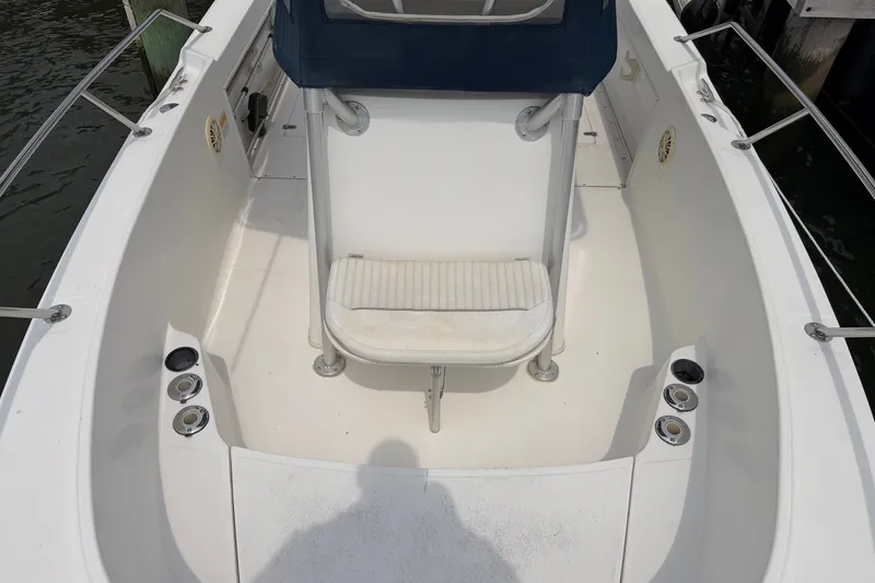 Slide: The Image of 2002 Boston Whaler 210 Outrage boat interior with seating and cup holders. - 17
