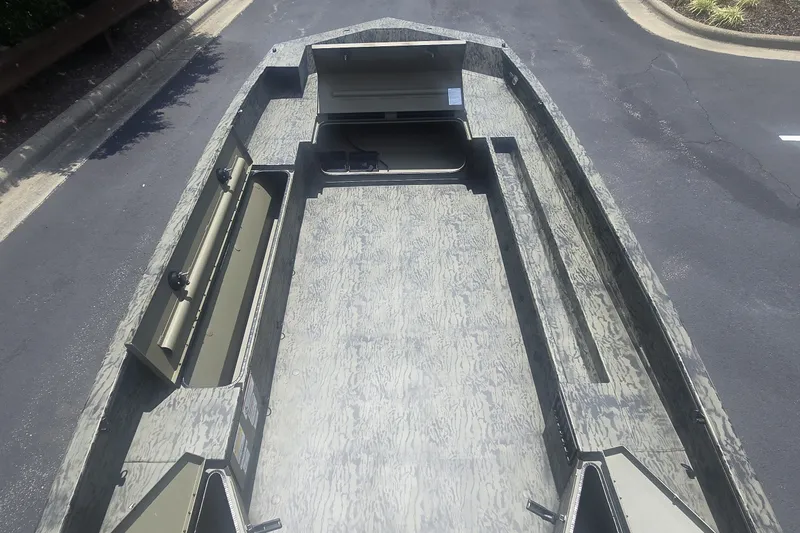 Slide: The Image of 2027 Tracker Grizzly 1860 CC boat interior, spacious deck, camo pattern, ideal for fishing. - 64