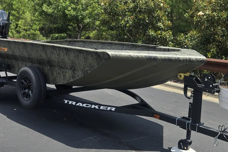 Slide: The Image of 2027 Tracker Grizzly 1860 CC boat on trailer, parked outdoors. - 63