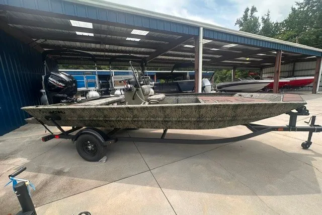 The Image of 2027 Tracker Grizzly 1860 CC boat on trailer in covered storage area. - 0