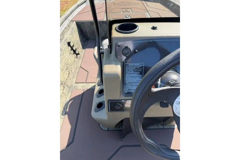 Slide: The Image of 2027 Tracker Grizzly 1860 CC boat console with steering wheel and control panel. - 14