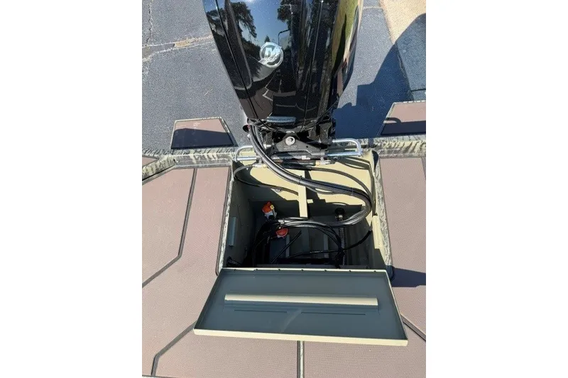 Slide: The Image of 2027 Tracker Grizzly 1860 CC boat engine compartment with open hatch. - 16