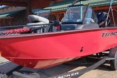 The Image of Red 2027 Tracker Targa V-18 Combo boat on trailer, parked outdoors. - 0