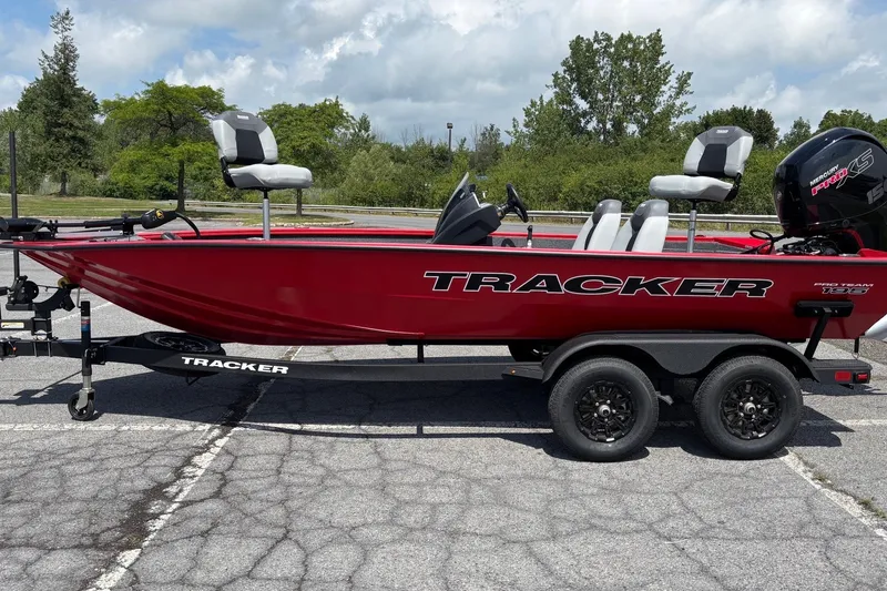 The Image of Red 2027 Tracker Pro Team 195 boat on trailer in parking lot. - 0
