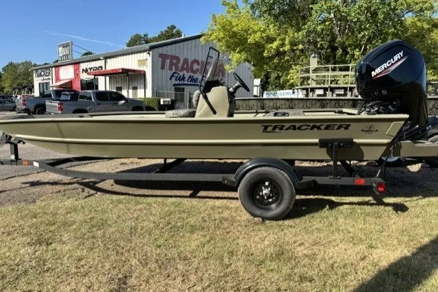 The Image of 2027 Tracker Grizzly 1860 CC boat with Mercury engine on trailer, parked outdoors. - 0