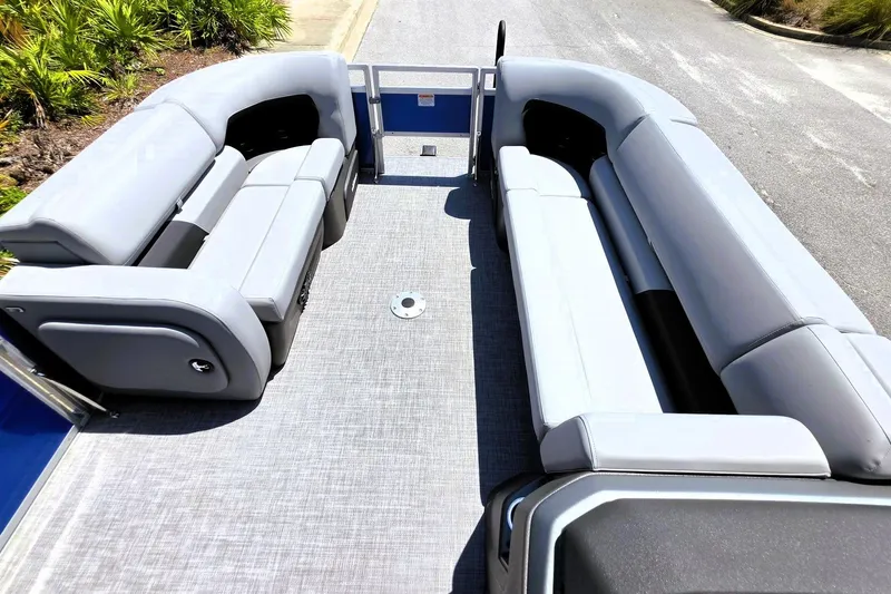 Slide: The Image of 2027 Sun Tracker SportFish 22 DLX pontoon boat interior with gray seating and spacious layout. - 17