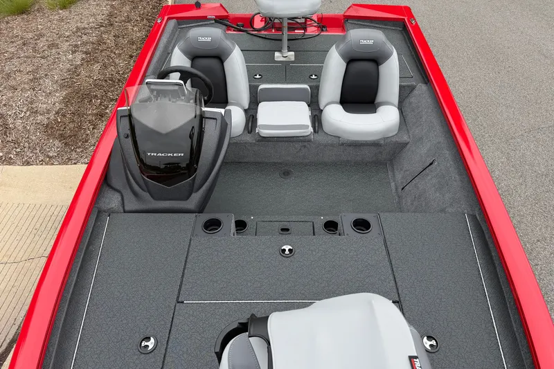 Slide: The Image of 2027 Tracker Pro Team 195 boat interior with red exterior, gray seating, and steering console. - 36