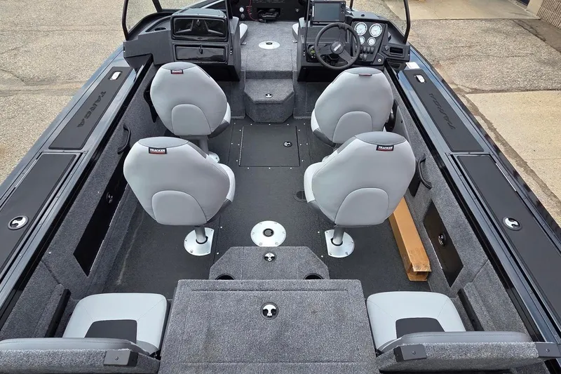 Slide: The Image of Interior of 2027 Tracker Targa V-18 Combo boat with four gray seats and steering console. - 41