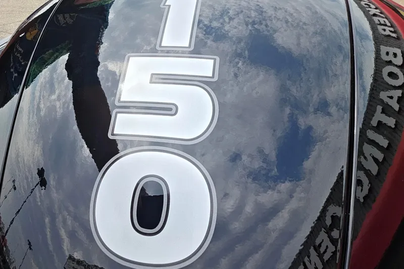 Slide: The Image of Close-up of Tracker Targa V-18 Combo 2027 boat with "150" decal and sky reflection. - 42