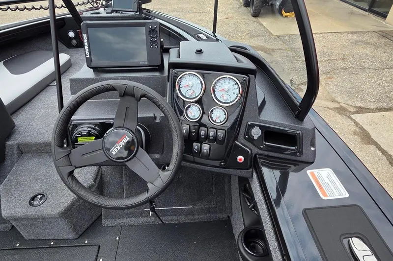Slide: The Image of 2027 Tracker Targa V-18 Combo boat dashboard with steering wheel and gauges. - 43