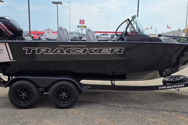 Slide: The Image of 2027 Tracker Targa V-18 Combo boat on trailer, displayed outdoors. - 36