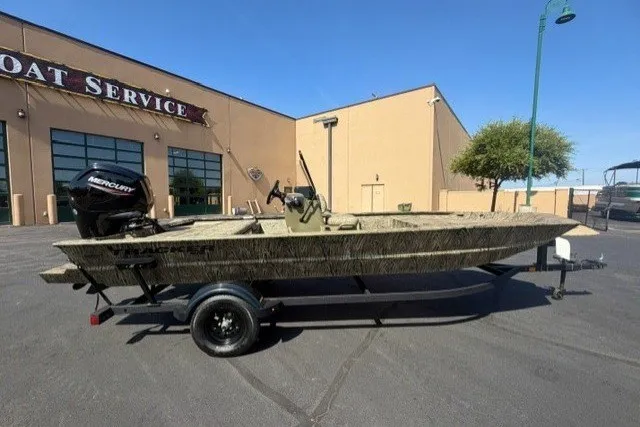 The Image of 2027 Tracker Grizzly 1860 CC boat on trailer outside service center. - 0