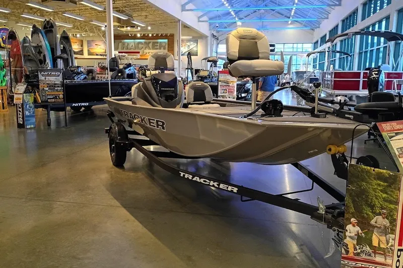The Image of 2027 Tracker Pro 170 boat displayed in a showroom with various other boats. - 0