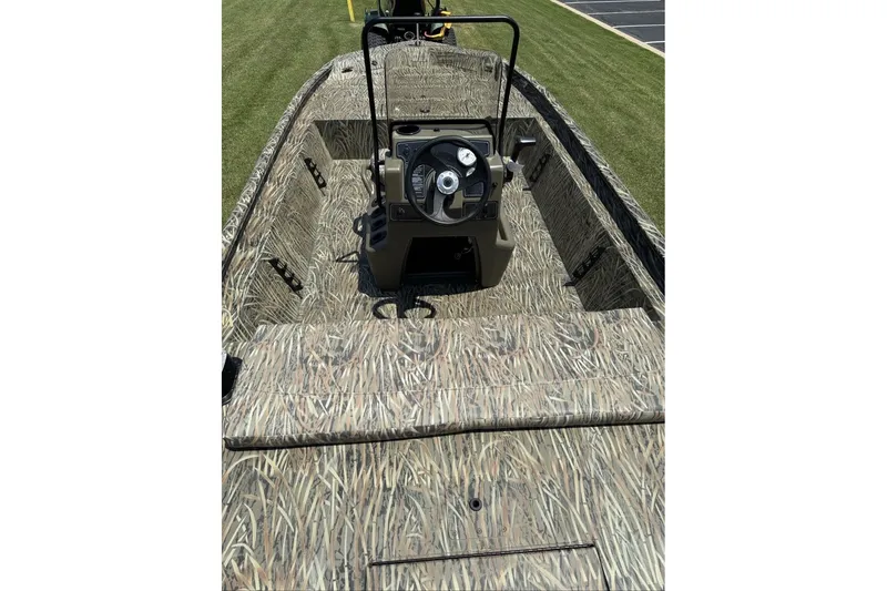 Slide: The Image of 2027 Tracker Grizzly 1860 CC boat with camouflage interior and steering console. - 72