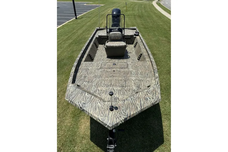 Slide: The Image of 2027 Tracker Grizzly 1860 CC boat with camouflage design on grass. - 71