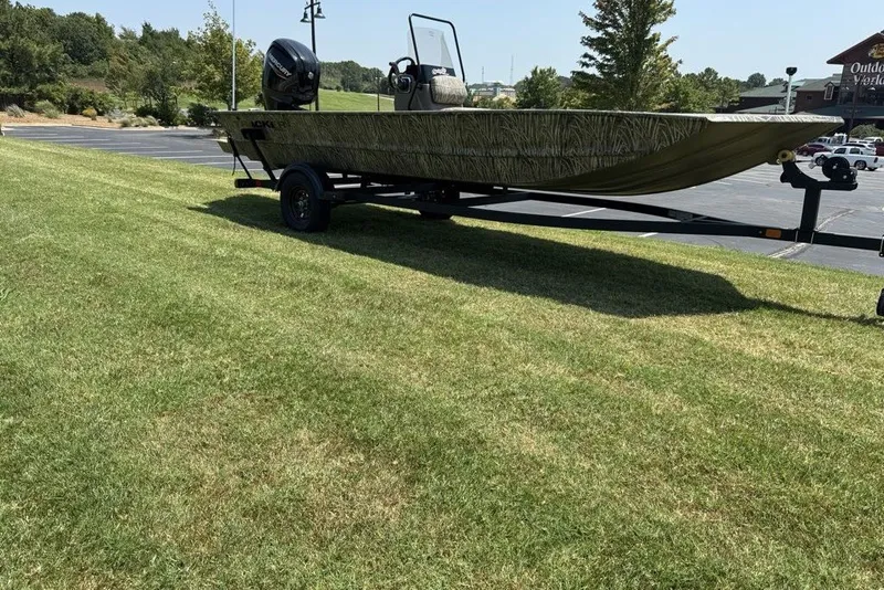 The Image of 2027 Tracker Grizzly 1860 CC boat on trailer, parked on grassy area. - 0