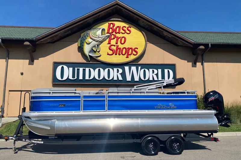The Image of 2027 Sun Tracker SportFish 22 DLX pontoon boat outside Bass Pro Shops Outdoor World. - 0