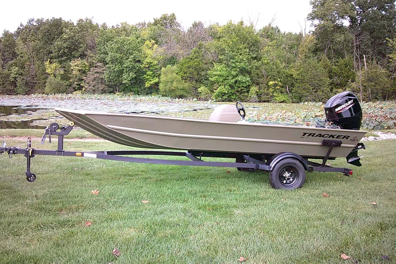 The Image of 2027 Tracker Grizzly 1754 SC boat on trailer by a scenic lake. - 0