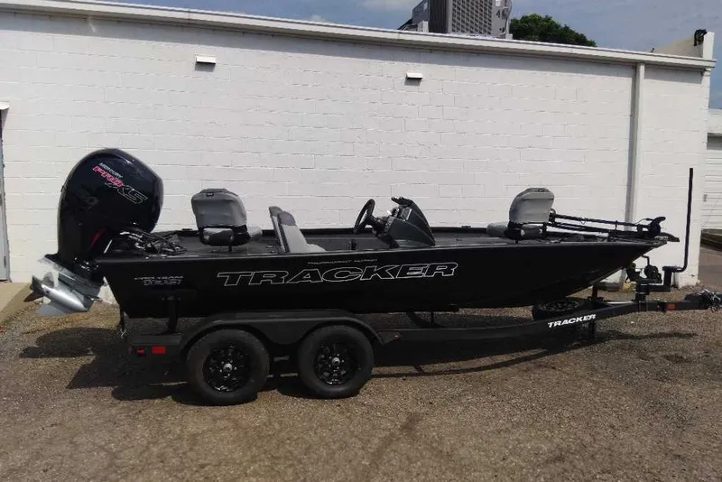 The Image of 2027 Tracker Pro Team 195 boat on trailer, parked outdoors. - 0