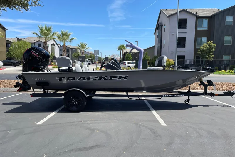 The Image of 2027 Tracker Pro Team 190 boat on trailer in parking lot, sunny day. - 0