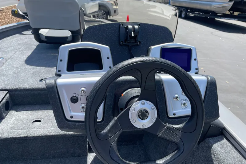 Slide: The Image of Steering console of 2027 Tracker Pro Team 190 boat with controls and display. - 16