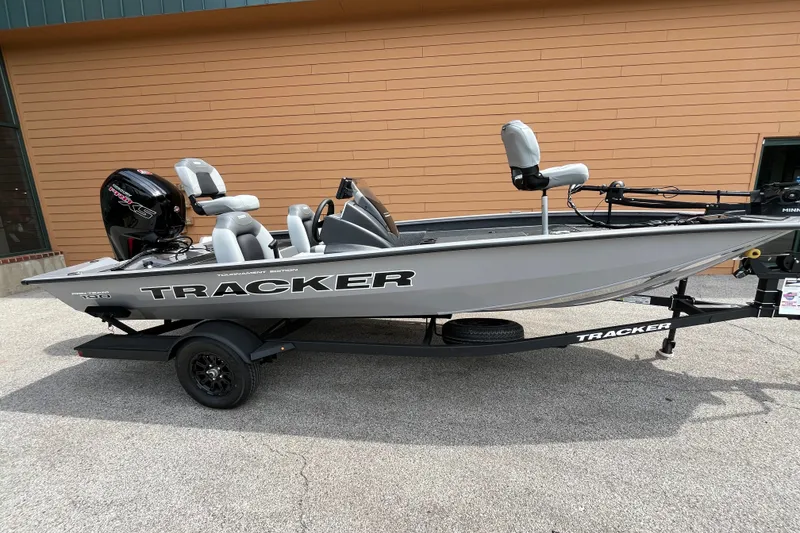 The Image of 2027 Tracker Pro Team 190 fishing boat on trailer, parked outdoors. - 0