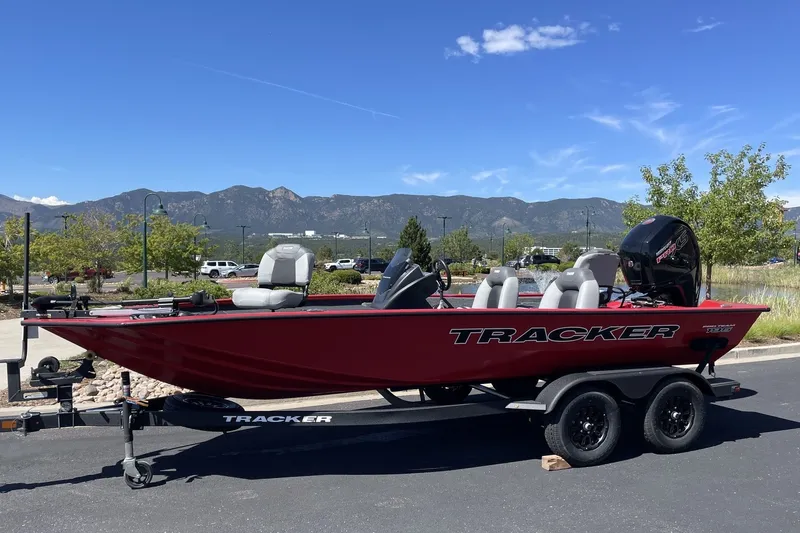 Slide: The Image of 2027 Tracker Pro Team 195 boat on trailer, parked with scenic mountain backdrop. - 14