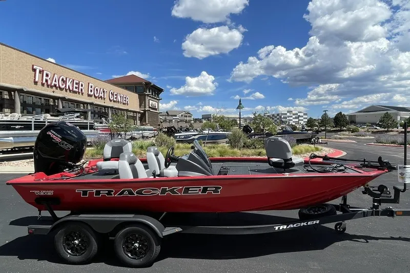 Slide: The Image of Red 2027 Tracker Pro Team 195 boat at Tracker Boat Center under a blue sky. - 12