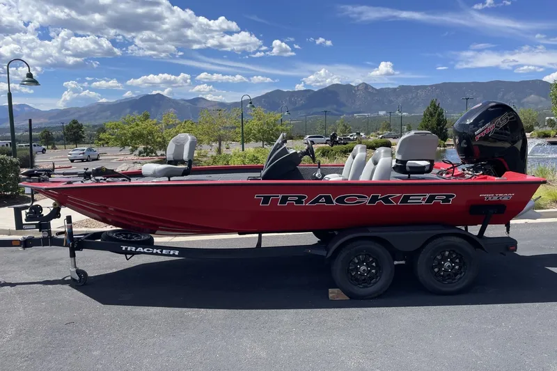 Slide: The Image of Red 2027 Tracker Pro Team 195 boat on trailer, scenic mountain backdrop. - 15