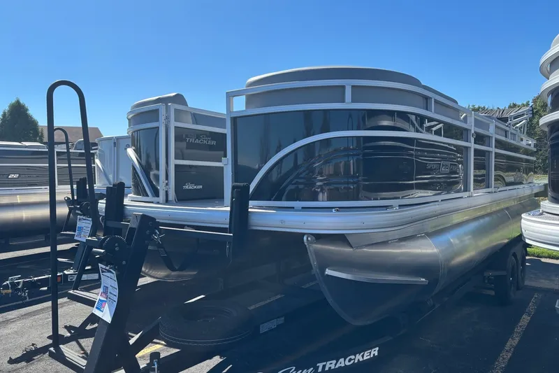 The Image of 2027 Sun Tracker SportFish 22 DLX pontoon boat on trailer, outdoor display. - 0