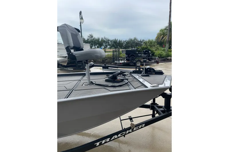 Slide: The Image of 2027 Tracker Pro 170 boat on trailer, featuring a swivel seat and fishing equipment. - 30