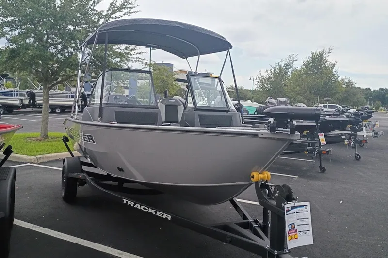 The Image of 2027 Tracker Pro Guide V-16 WT boat on trailer in outdoor showroom. - 0