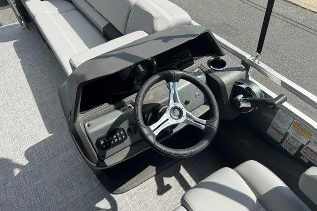 Slide: The Image of 2027 Sun Tracker SportFish 22 DLX boat interior with steering wheel and seating. - 14