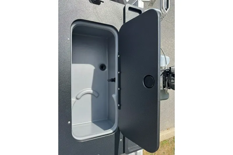 Slide: The Image of Open storage compartment on 2027 Sun Tracker SportFish 22 DLX boat. - 18
