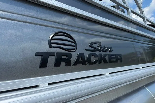 Slide: The Image of 2027 Sun Tracker SportFish 22 DLX logo on sleek metallic surface. - 25