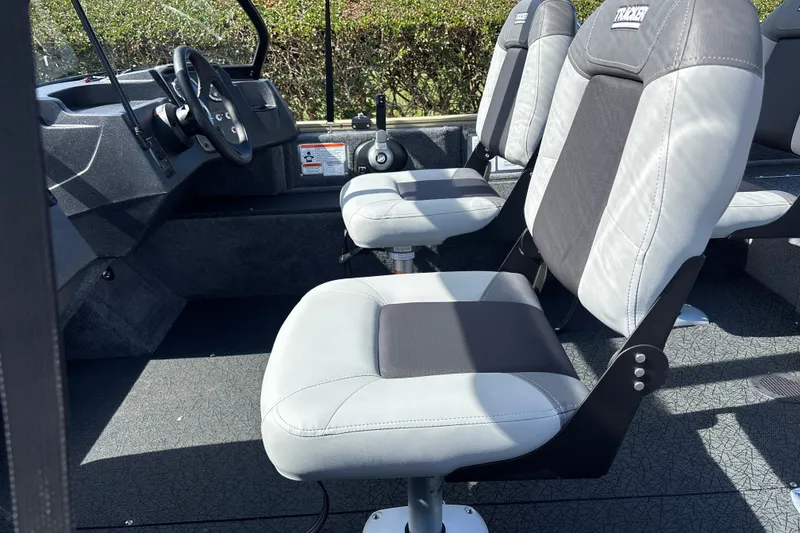 Slide: The Image of 2027 Tracker Pro Guide V-16 WT boat interior with comfortable seating and steering wheel. - 18