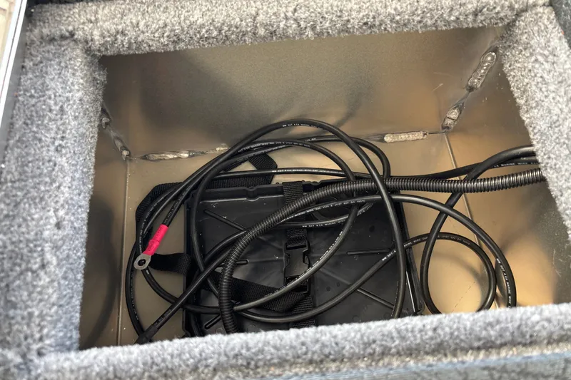 Slide: The Image of Storage compartment with cables in a 2027 Tracker Pro Guide V-16 WT boat. - 34