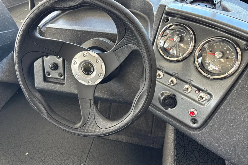 Slide: The Image of Steering wheel and dashboard of 2027 Tracker Pro Guide V-16 WT boat. - 19