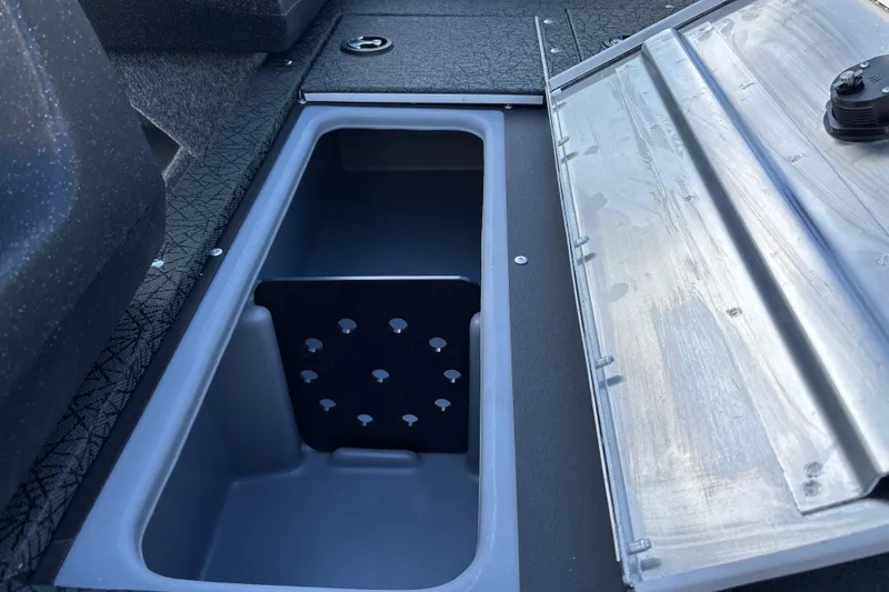 Slide: The Image of 2027 Tracker Pro Guide V-16 WT boat storage compartment with open lid. - 27