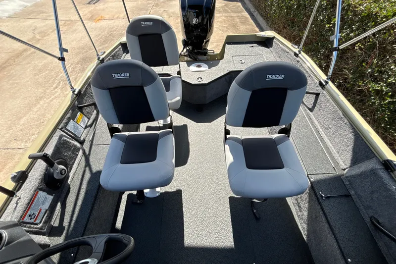 Slide: The Image of 2027 Tracker Pro Guide V-16 WT boat interior with two cushioned seats and steering console. - 15