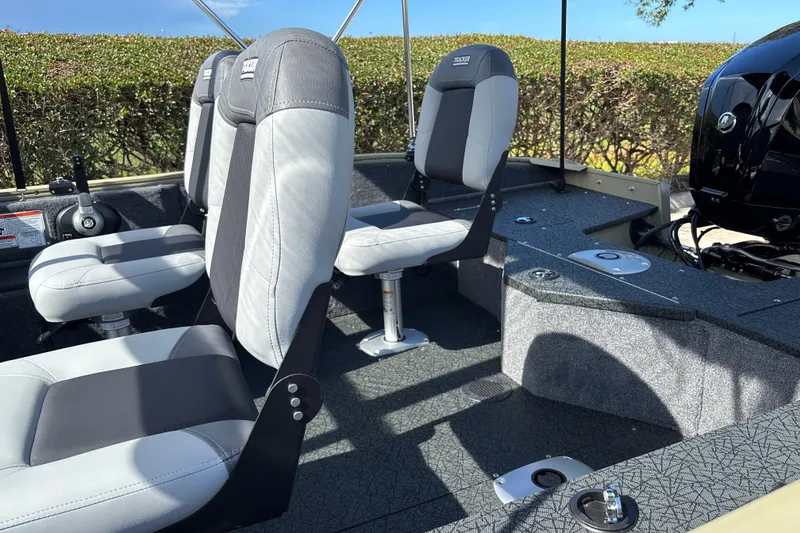 Slide: The Image of 2027 Tracker Pro Guide V-16 WT boat interior with gray seating and modern design. - 17